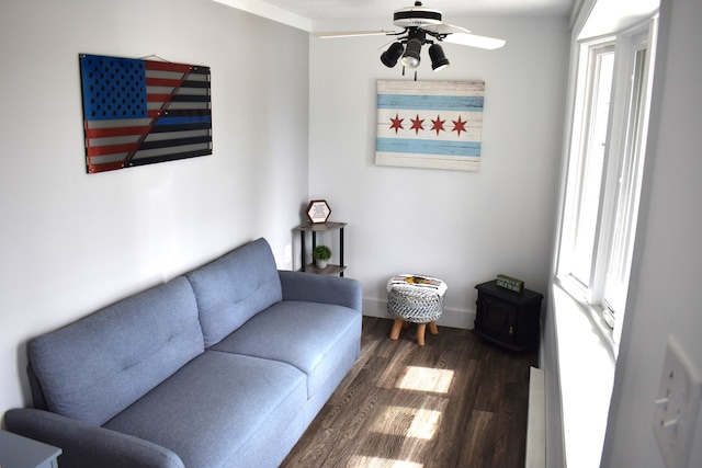 living room with ceiling fan, dark hardwood / wood-style flooring, a healthy amount of sunlight, and ornamental molding