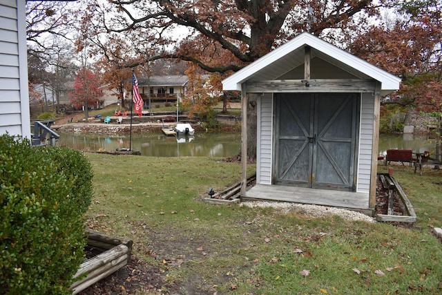 view of shed with a water view