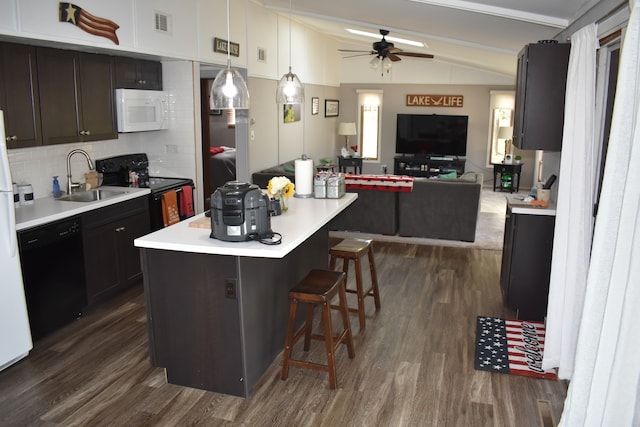 kitchen with lofted ceiling, black appliances, sink, hanging light fixtures, and a kitchen island