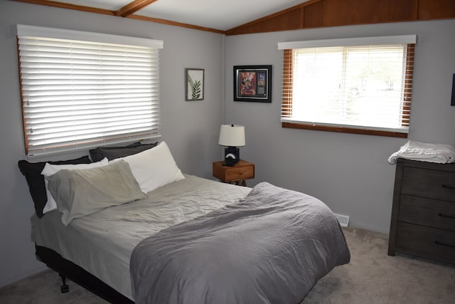 carpeted bedroom featuring lofted ceiling