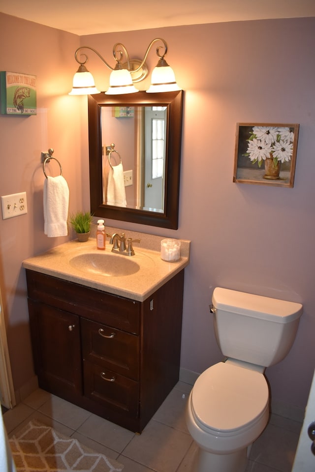 bathroom featuring tile patterned floors, vanity, and toilet