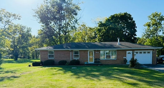 ranch-style home with a garage and a front lawn