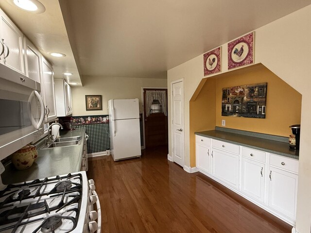 kitchen with sink, white appliances, decorative backsplash, white cabinets, and light wood-type flooring