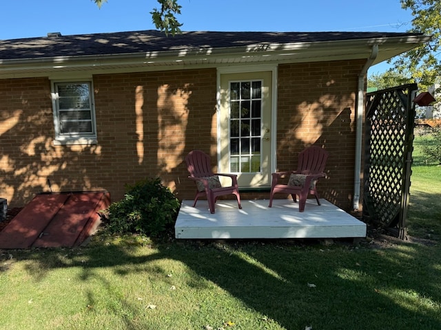 back of house featuring a yard and a deck