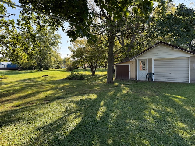 view of yard featuring an outbuilding and a garage