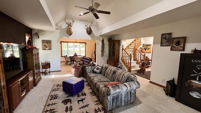 living area featuring ceiling fan with notable chandelier, vaulted ceiling, light carpet, and stairway