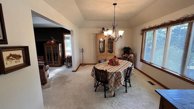dining room featuring visible vents, lofted ceiling, light carpet, baseboards, and a chandelier
