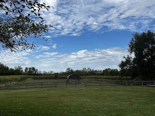 view of yard featuring a rural view and fence