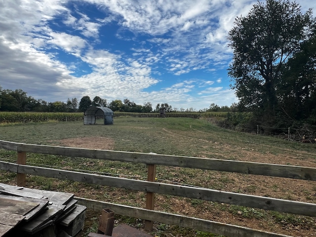 view of yard featuring a rural view and an outbuilding