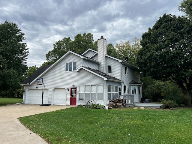 view of front of home with a front yard and a garage