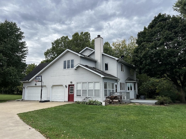 view of front of house with a front lawn, driveway, and a chimney