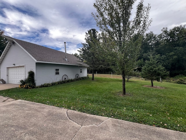 exterior space featuring a garage and a yard