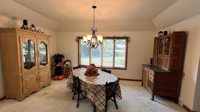 dining area featuring light colored carpet, baseboards, lofted ceiling, and an inviting chandelier