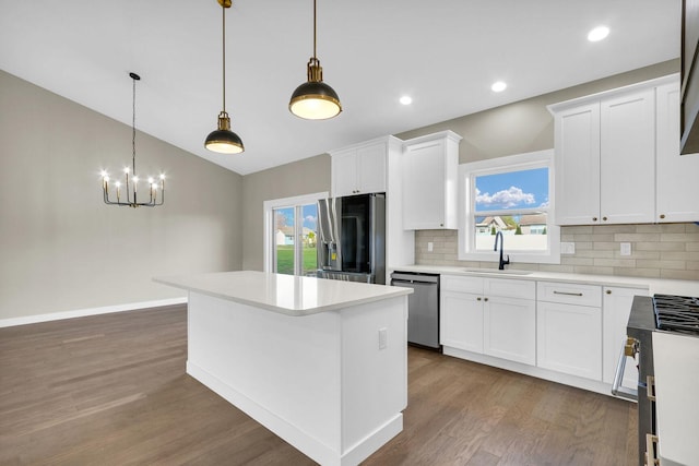 kitchen with white cabinetry, a healthy amount of sunlight, sink, and stainless steel appliances