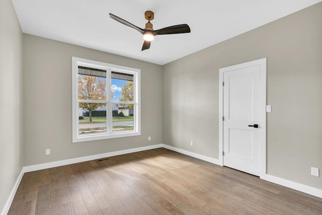 empty room featuring light wood-type flooring and ceiling fan