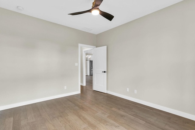 spare room with ceiling fan and hardwood / wood-style flooring