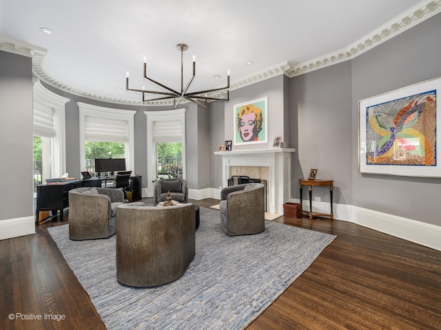 living room with an inviting chandelier, dark hardwood / wood-style floors, a fireplace, and crown molding