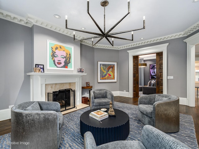 living room featuring an inviting chandelier, a tiled fireplace, and dark wood-type flooring