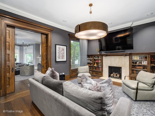 living room with a fireplace, recessed lighting, wood finished floors, and ornamental molding