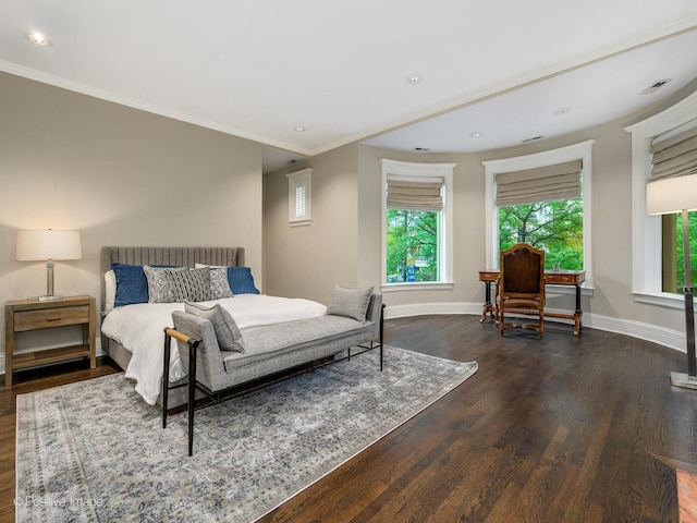 bedroom featuring dark wood finished floors, baseboards, and crown molding