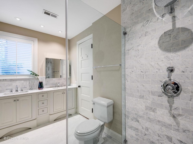 full bath with a sink, a tile shower, and visible vents