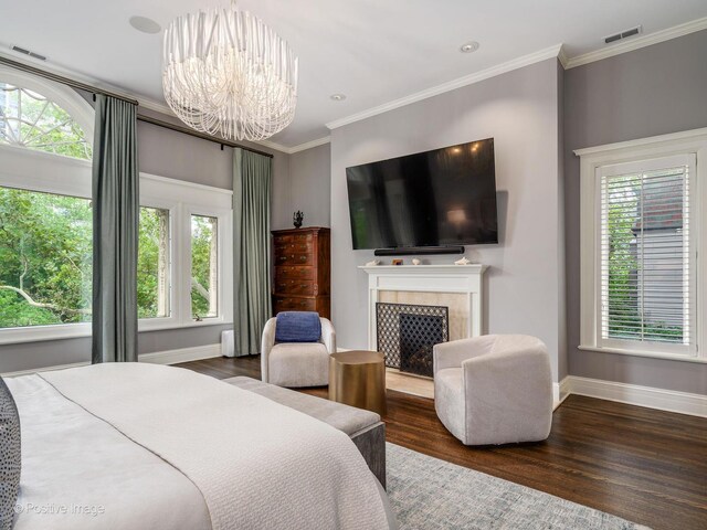 bedroom with ornamental molding, visible vents, a chandelier, and wood finished floors