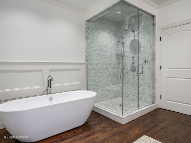 bathroom with independent shower and bath, hardwood / wood-style flooring, and crown molding