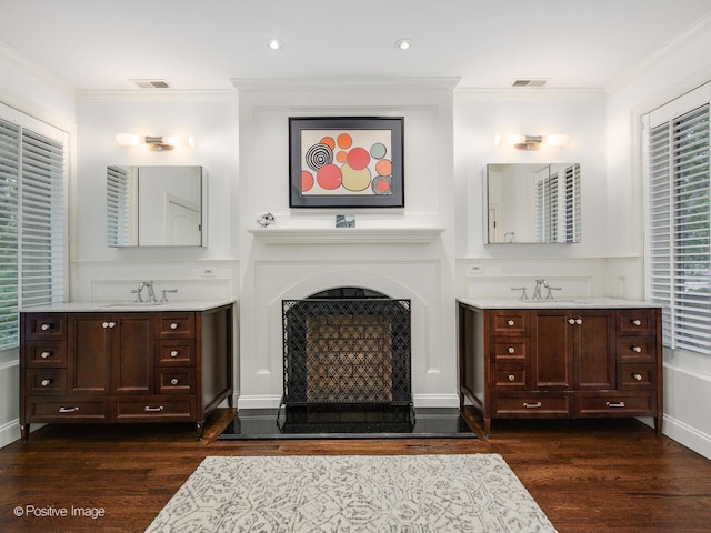 bathroom with crown molding, vanity, and hardwood / wood-style flooring