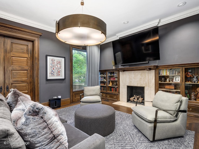 living room with ornamental molding, hardwood / wood-style floors, and a fireplace