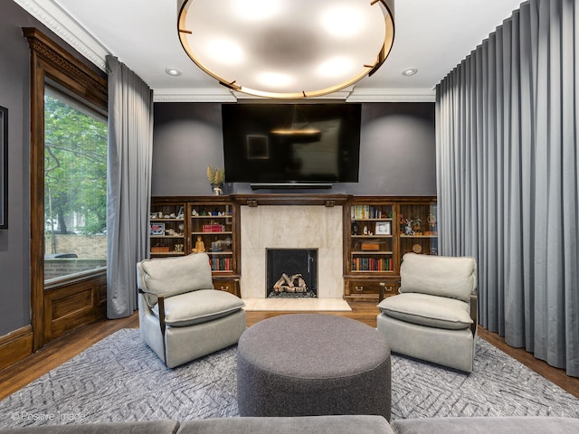 living room with ornamental molding, hardwood / wood-style floors, and a premium fireplace