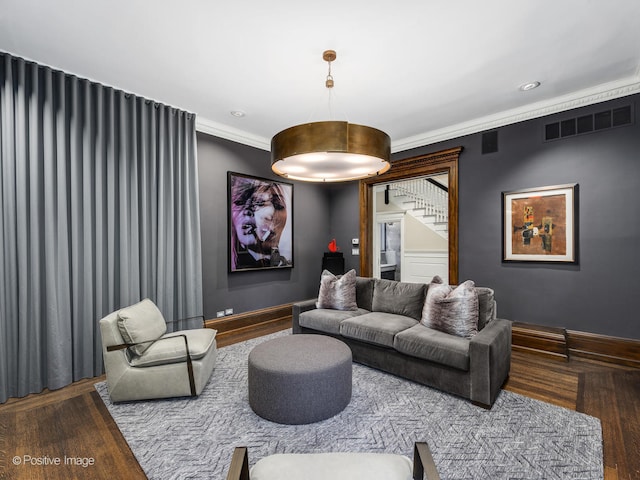 living room featuring wood-type flooring and ornamental molding