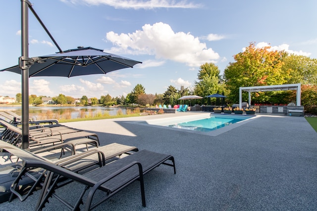 view of swimming pool with a patio, a water view, and a pergola