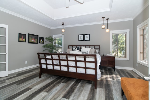 bedroom with multiple windows, dark hardwood / wood-style floors, and crown molding