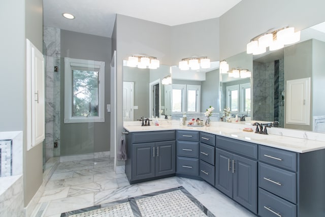 bathroom with vanity, a shower with door, and a wealth of natural light