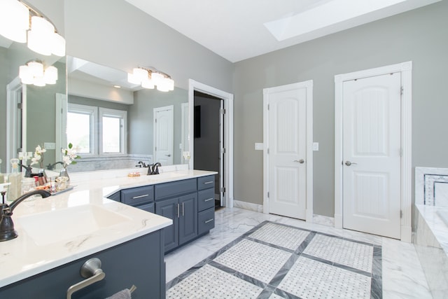 bathroom featuring a skylight and vanity