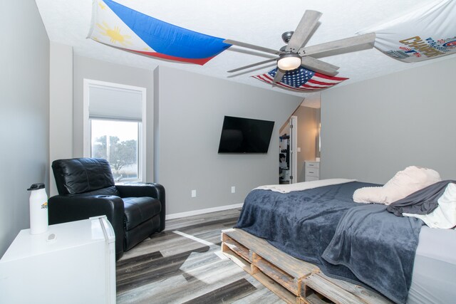 bedroom with wood-type flooring and ceiling fan