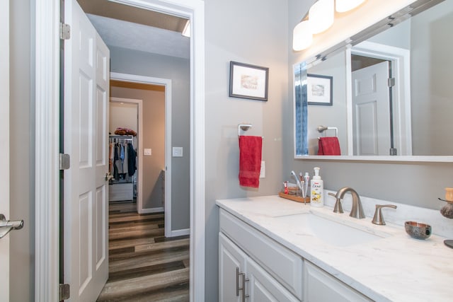 bathroom with vanity, hardwood / wood-style floors, and a textured ceiling