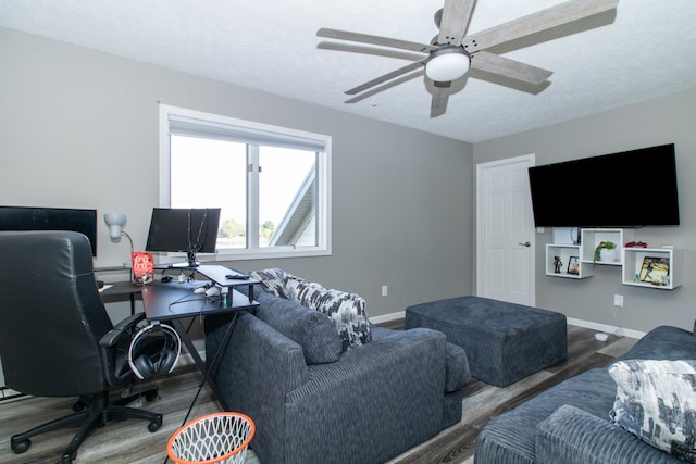 office area featuring ceiling fan, a textured ceiling, and dark hardwood / wood-style flooring