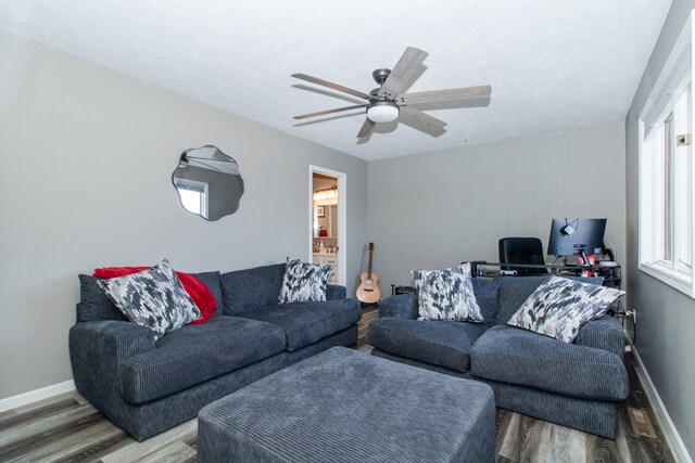 living room featuring hardwood / wood-style floors and ceiling fan