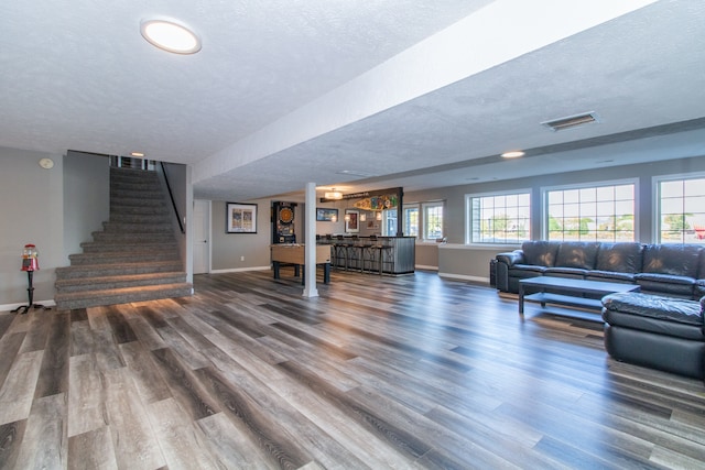 living room featuring a textured ceiling and hardwood / wood-style flooring