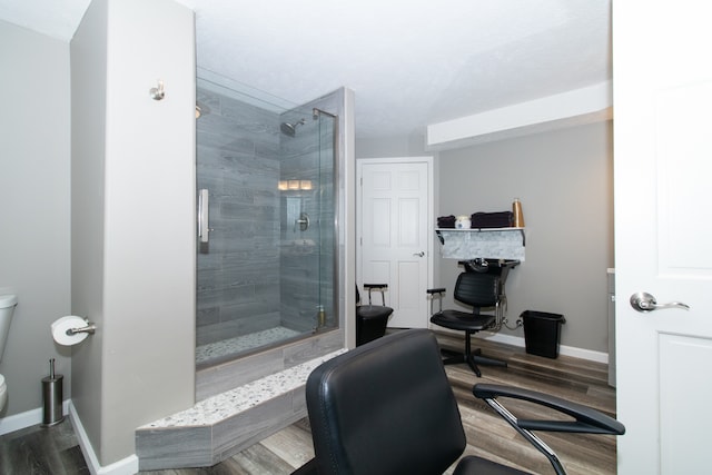 interior space featuring wood-type flooring, walk in shower, and toilet