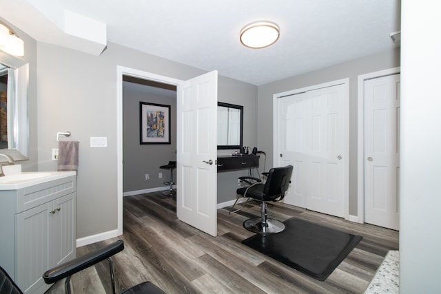 office area with dark wood-type flooring and sink