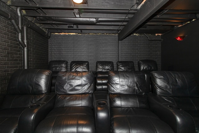 home theater with brick wall