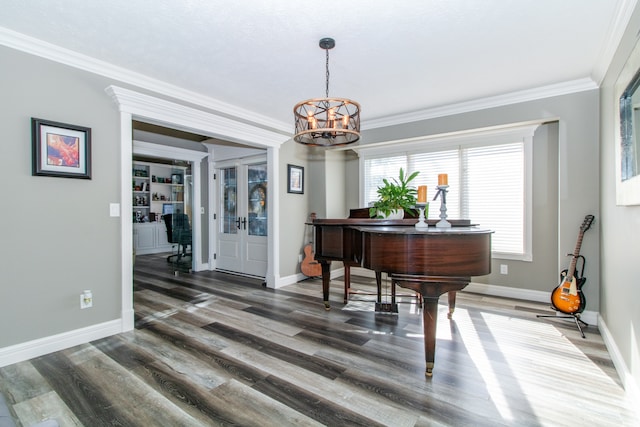 interior space featuring an inviting chandelier, dark hardwood / wood-style floors, and ornamental molding