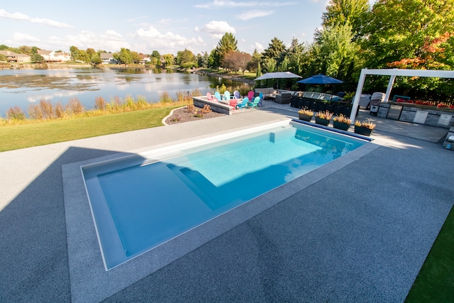 view of swimming pool with a water view and a patio area