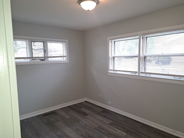 unfurnished room featuring dark hardwood / wood-style flooring