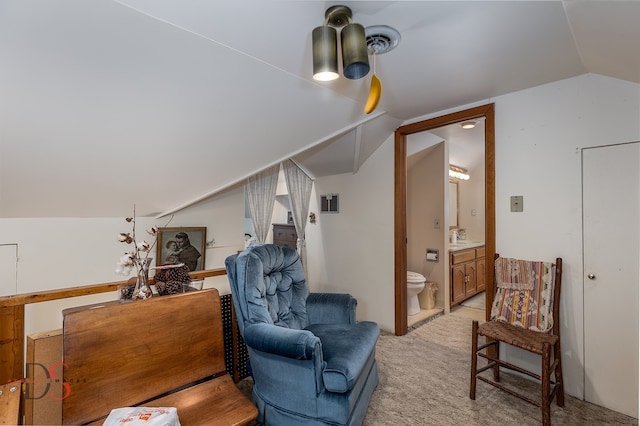 sitting room featuring vaulted ceiling, light colored carpet, and sink