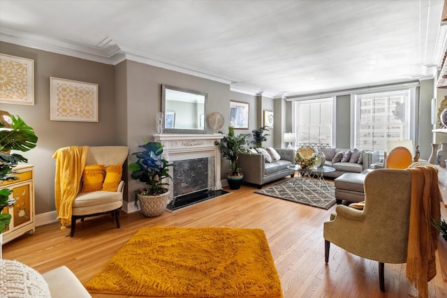 living room featuring ornamental molding, a premium fireplace, and hardwood / wood-style flooring