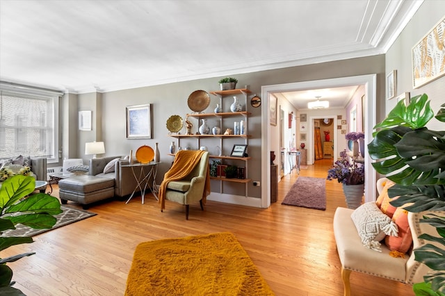 living room featuring ornamental molding and light wood-type flooring