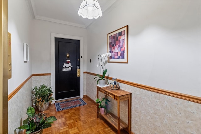 foyer entrance featuring crown molding and parquet flooring